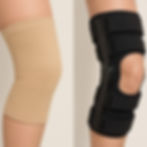 A simple, clear side-by-side photo showing a basic elastic compression sleeve on one side, and a rigid, hinged ligament knee brace on the other