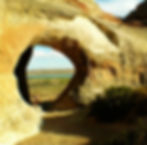 Looking through Wahweap Window, with Lake Powell, Antelope Island, and the Colorado Plateau in the background.