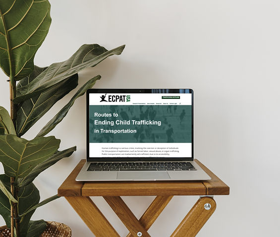 Laptop displaying the ECPAT-USA website homepage with the headline ‘Routes to Ending Child Trafficking in Transportation,’ shown on a small wooden table beside a houseplant.