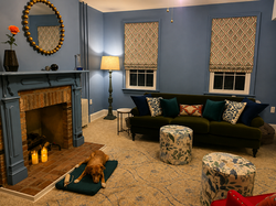 Joyful living area with a vibrant blue base on the walls mixed with beautiful patterns to add warmth