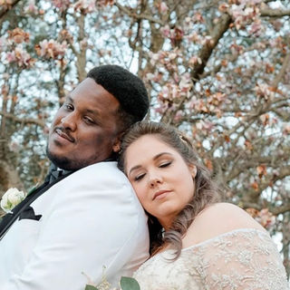 Bride and groom embracing outdoors after wedding ceremony