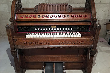Historic wooden pump organ with keyboard and decorative case