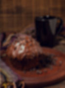 Close-up of moist cupcakes topped with rich chocolate icing