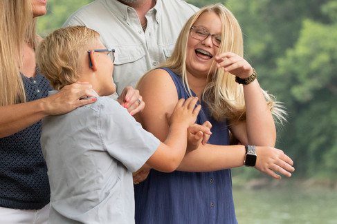 brother and sister playing on banks of Colorado River in photo session