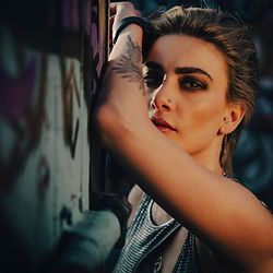 woman looking at camera with arm in face