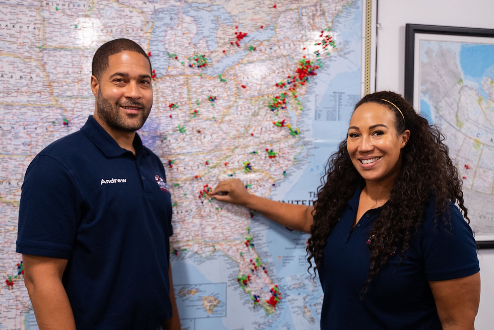 Tamara and her husband pointing to a map at British Swim School headquarters, marking their Alpharetta territory