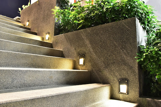 Hardwired light fixtures can be installed at the center or side of each stair riser to cast light onto each step.