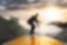 Man surfing on a yellow surfboard