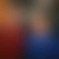 A man and a woman stands in front of blue hat for an award.