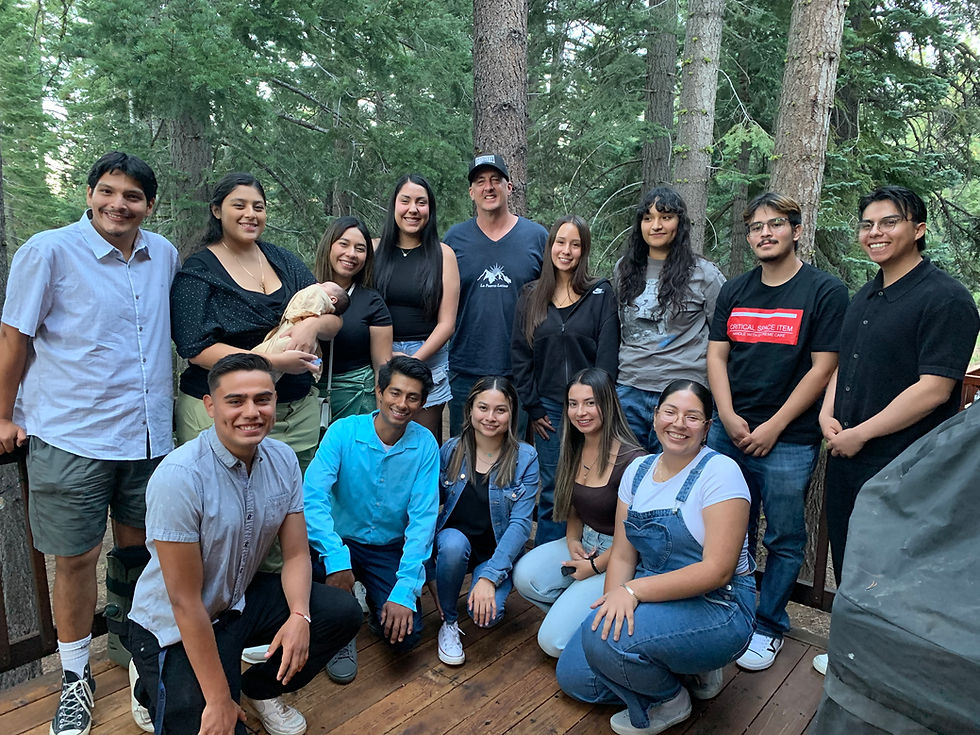 LFL students gathered on a patio with a forest backdrop
