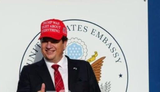 Adrian White criticized over pro-Trump hat at U.S. Embassy