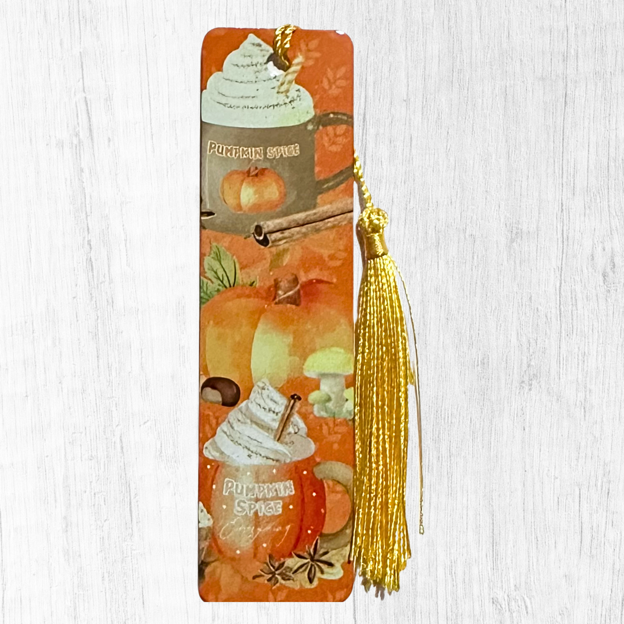 Fall bookmark with pumpkin spice drinks, pumpkins and gold tassel