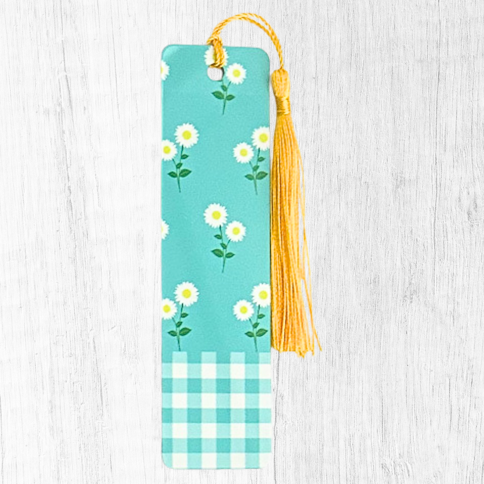 Teal checkered bookmark with small white daisies and yellow tassel