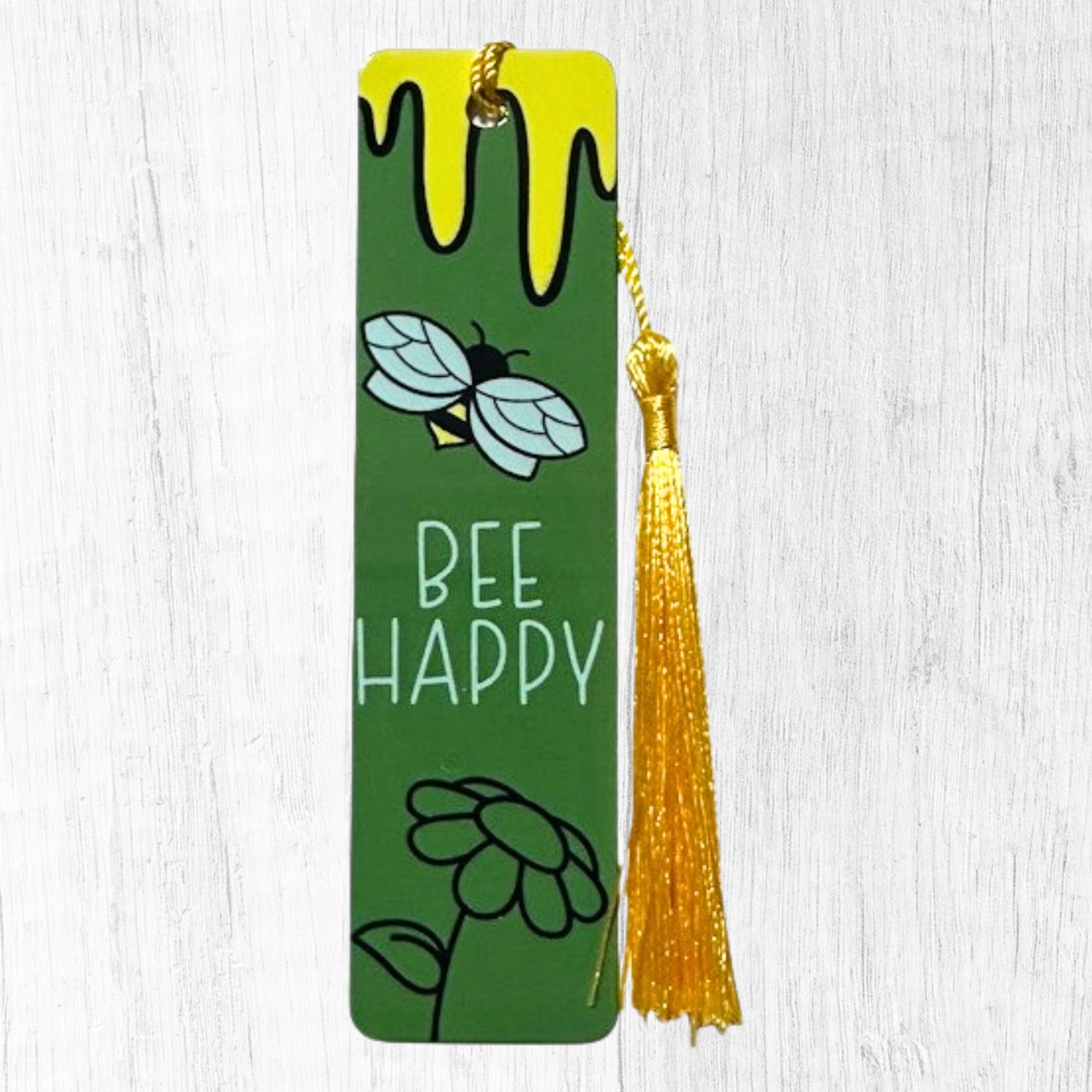 green bookmark with bee and honey drip design and yellow tassel