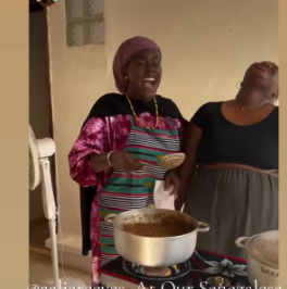 Local cook preparing a traditional Senegalese dish with fresh ingredients.
