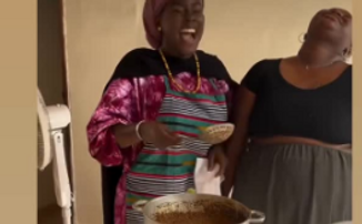 Local cook preparing a traditional Senegalese dish with fresh ingredients.