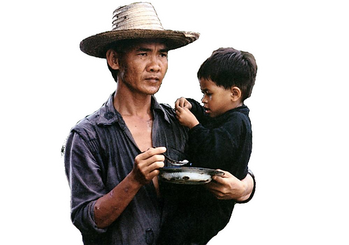 Still from Rolande Joffe's The Killing Fields of Dith Pran holding a child.