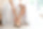 Bride in a beautiful wedding dress putting on shoes.jpg