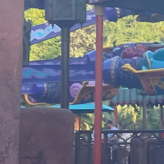 Magic Carpets of Aladdin ride vehicle at Magic Kingdom, designed as a colorful flying carpet with gold trim and jewel-toned seats, ready to take guests on a whimsical, high-flying adventure.