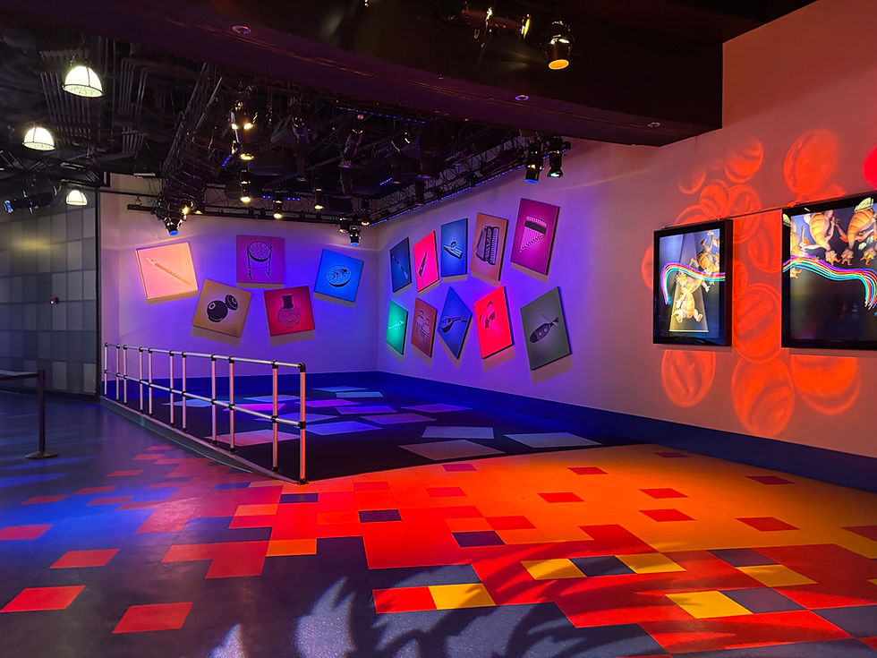 Colorful panels with musical instruments light up in a room.