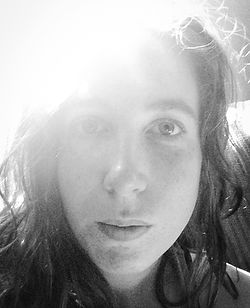 Black and white close up image of photographer Katie Adkins