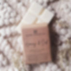 Top shot of a chunky soy wax snap bar beneath a hand wrapped wax melt bar in recycled kraft paper