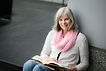 Photo of Cindy Chambers Johnson sitting with book by blackphotography.net for download