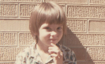 Photo of the author as a child with finger on chin
