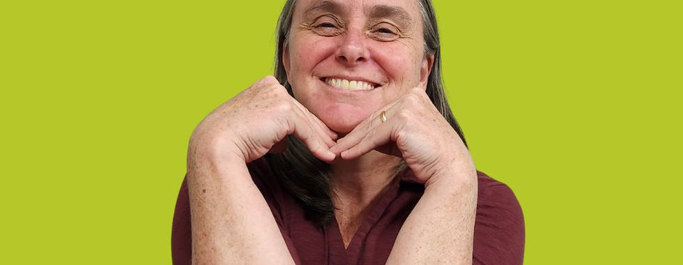 Lori Lilly with heart arms and Giving Tuesday Logo with green background