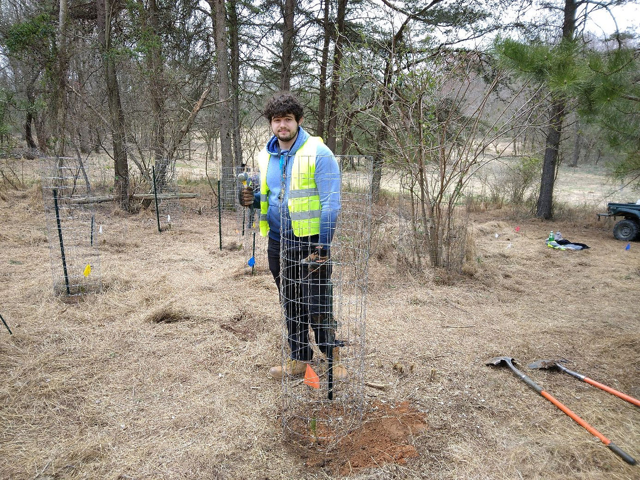 Evan and a tree he planted, at the Robinson nature conservancy