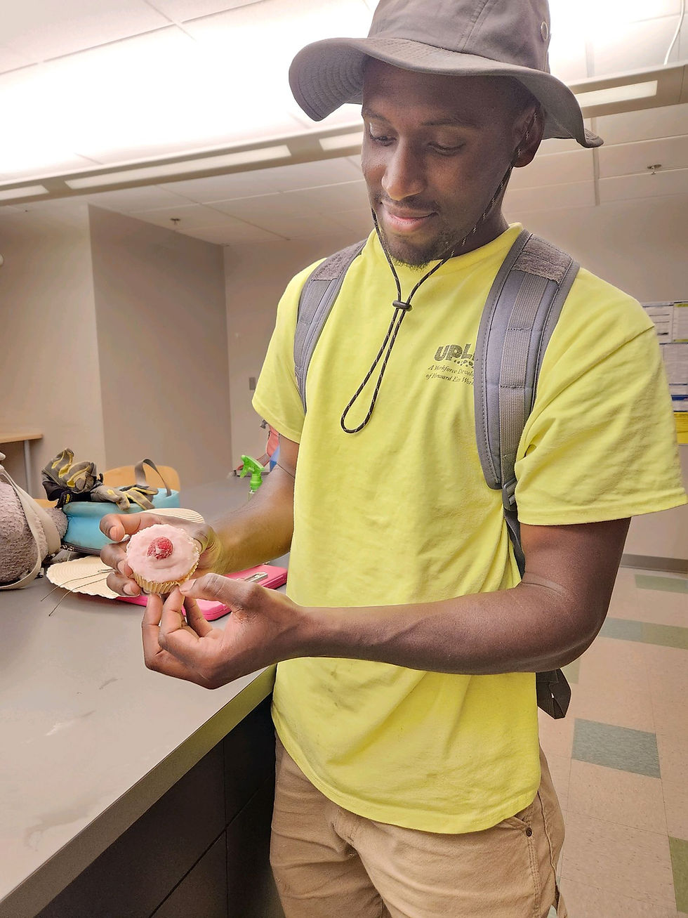 Markell holding a cupcake made from fellow crew members