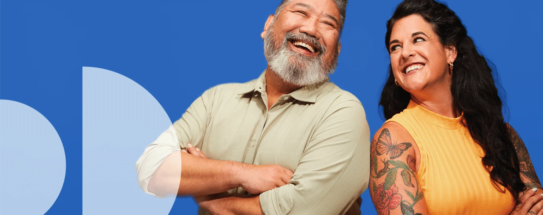 Man and woman standing sholder to sholder laughing
