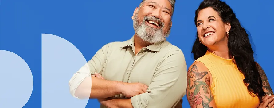 Man and woman standing sholder to sholder laughing