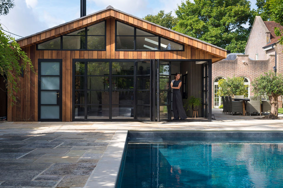 Origin bi-fold doors forming a glass wall in a property with a view of a swimming pool