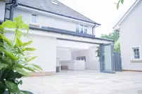 A white house with folding doors