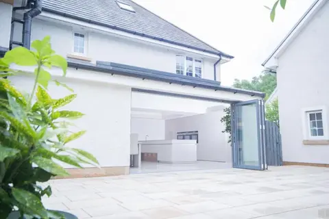 A white house with folding doors