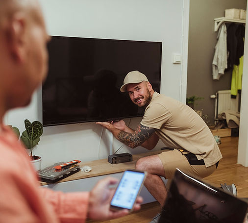 engineer inspecting TV in client's home