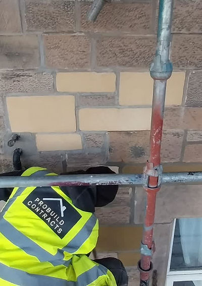 Builder repairing stone wall