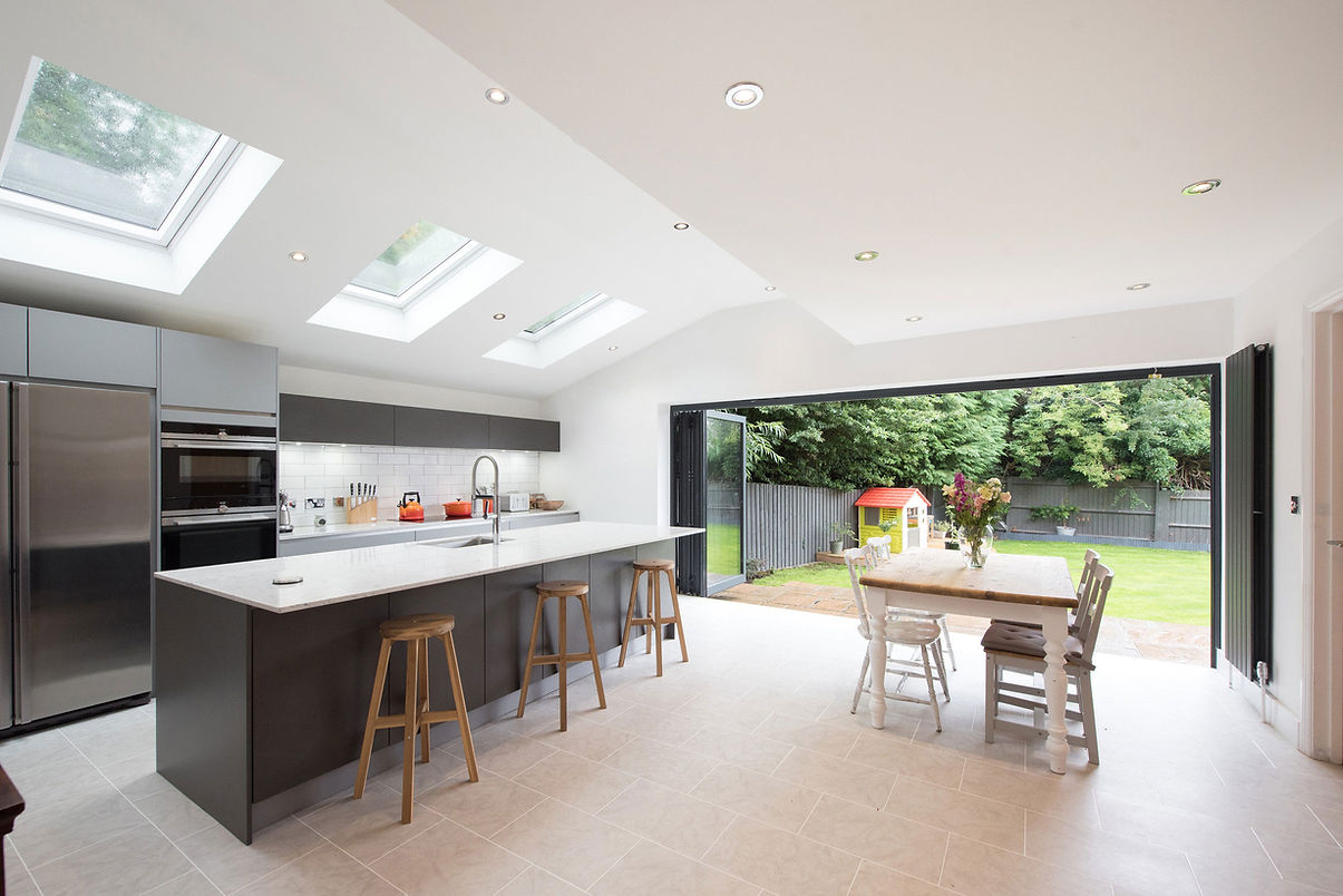 Kitchen dining, sky light windows and large bifold patio doors with view into the garden w
