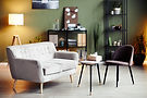 Waiting room with gray sofa and shelves
