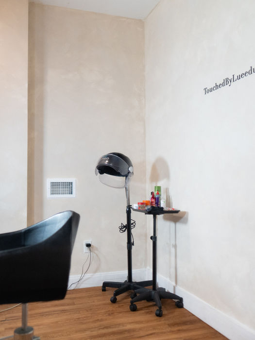 Salon suite with styling chair, dryer, and station