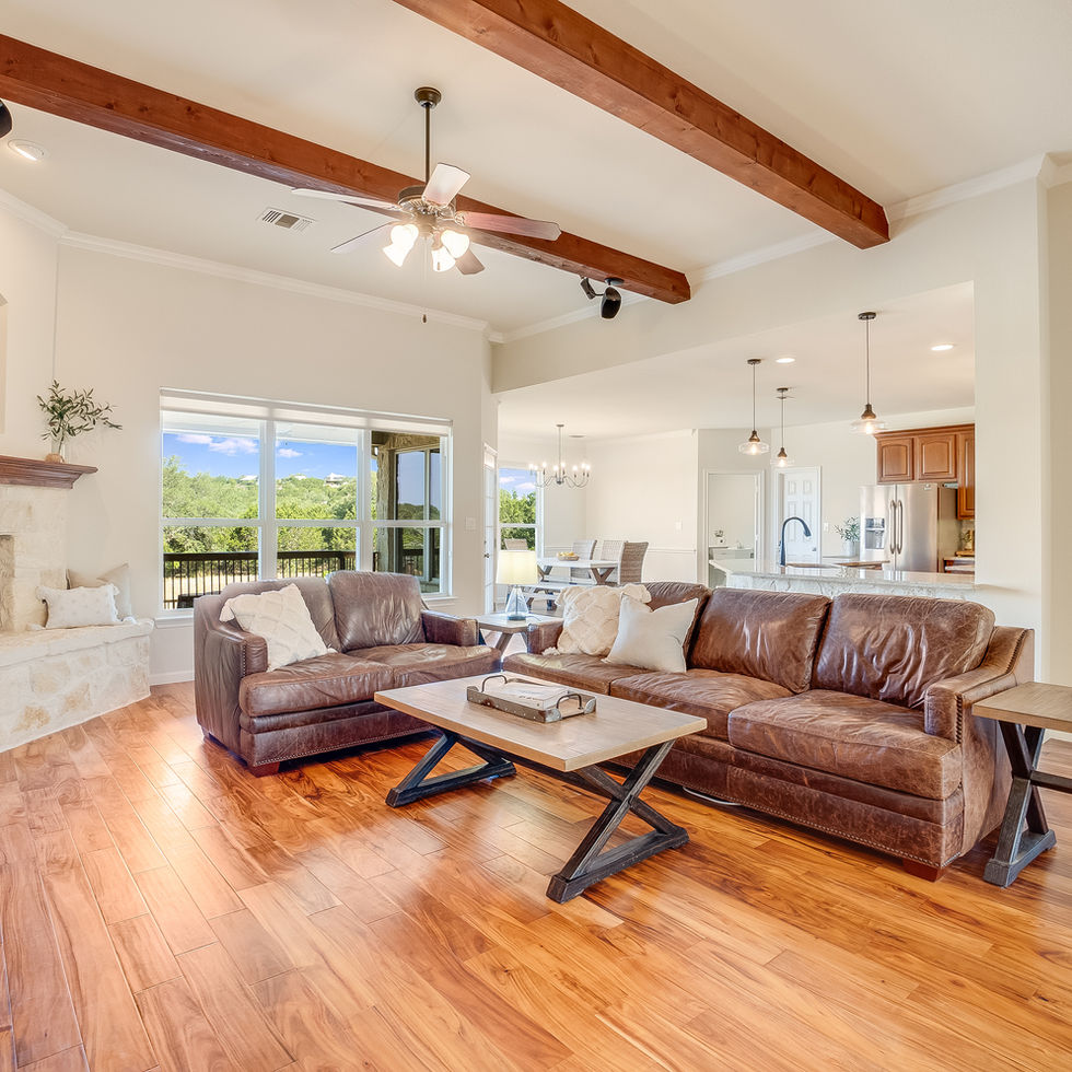 Living room with couches, fireplace, and view of the outside and scenery