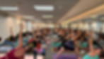 Yoga class with many people in a studio