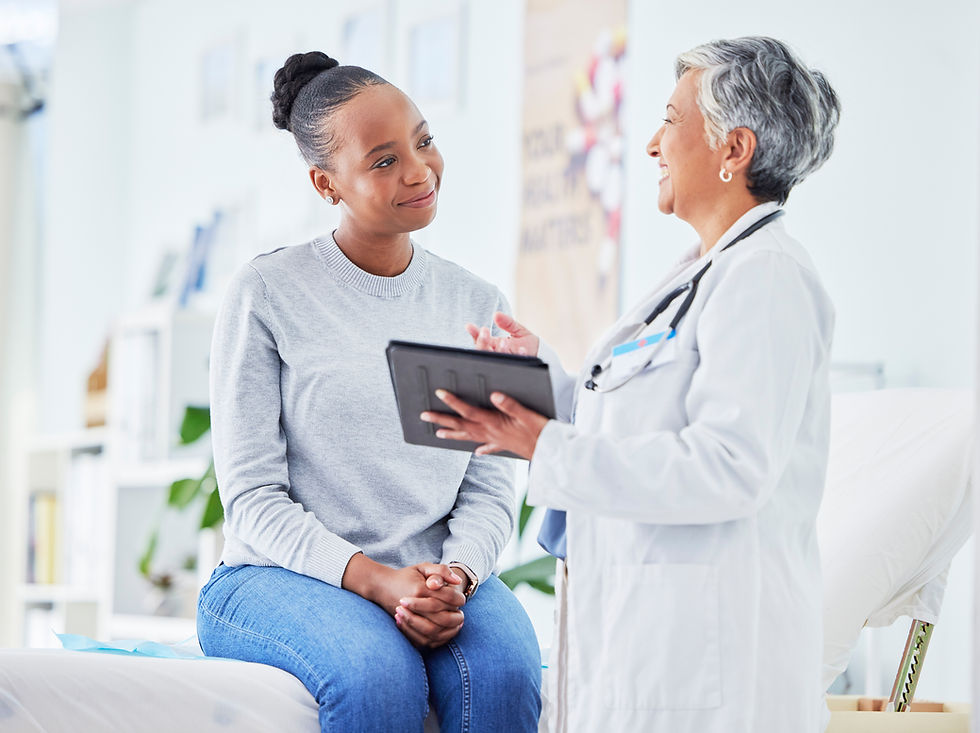 A woman attentively listens to her primary care doctor during a consultation, fostering a positive and communicative healthcare experience.