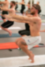 Man practicing a yoga balance pose on mat