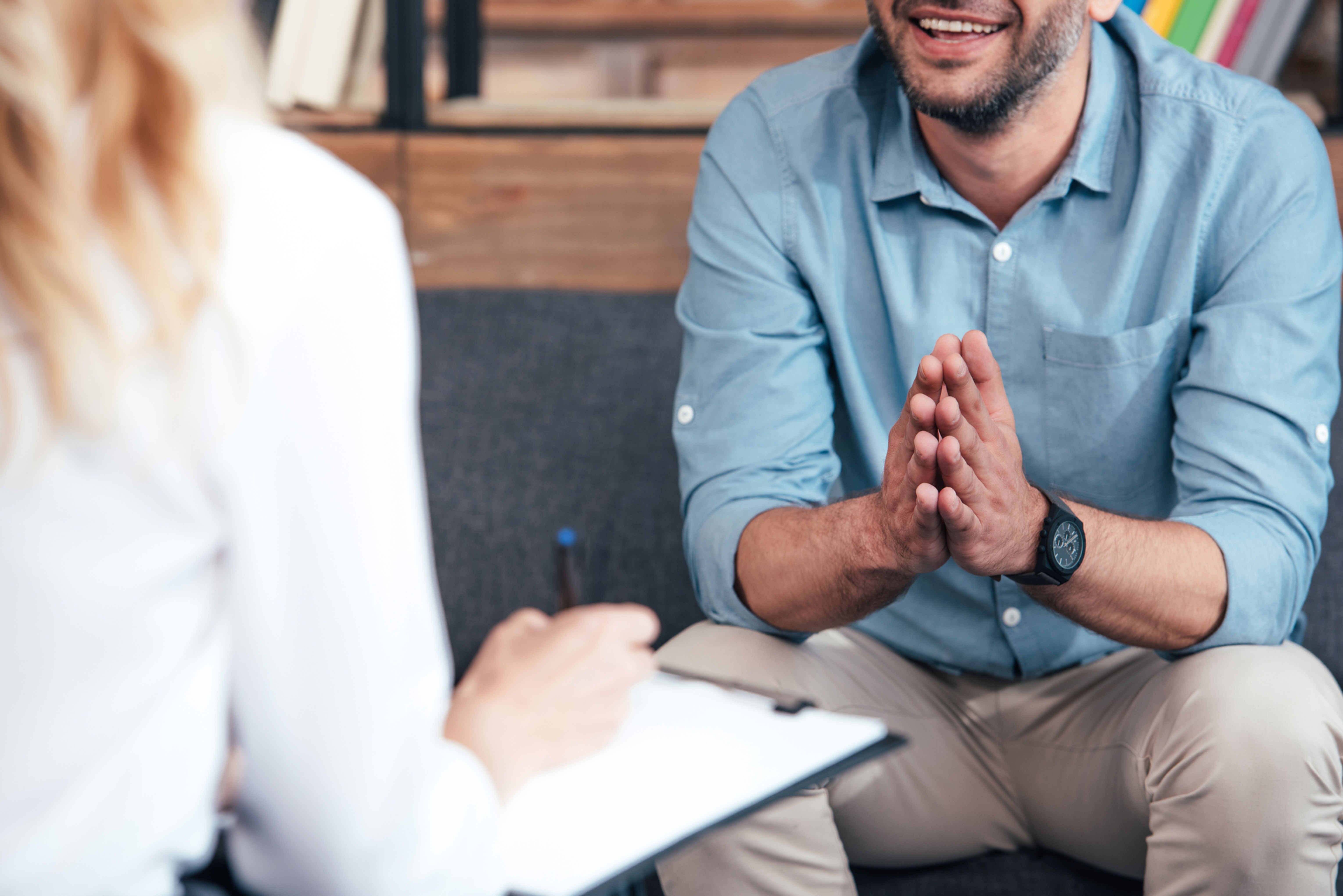 Man smiling and talking during individual counseling