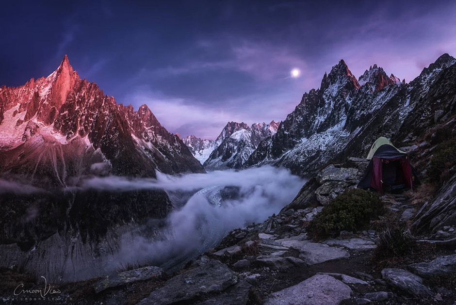snowed and foggy mountain ridge at sunset