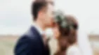 outdoor wedding photography groom kissing bride on the forehead