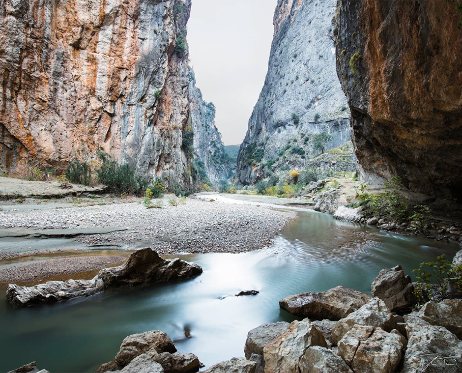 long exposure of river passing through canyon