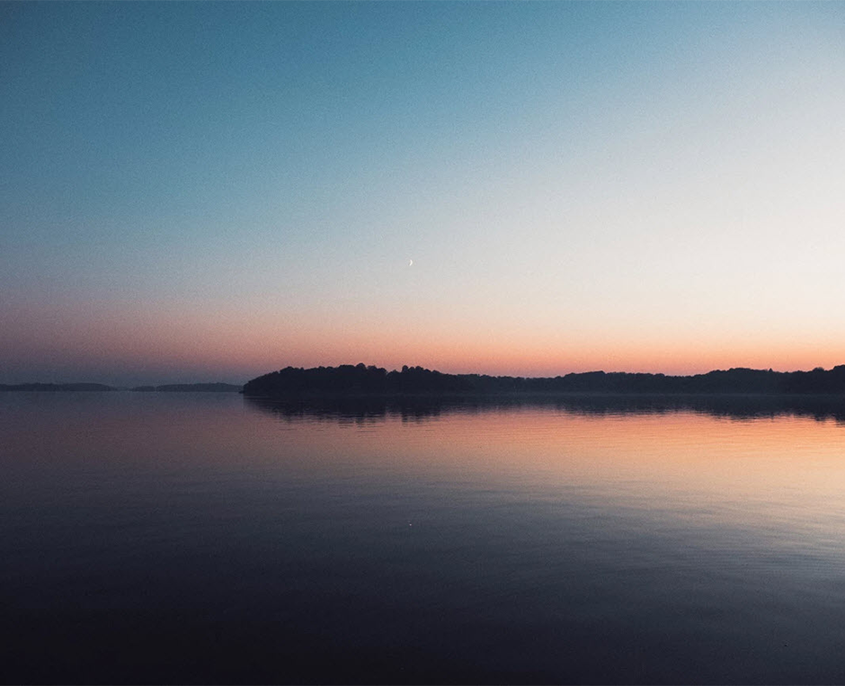 symmetric sunset over forest and lake